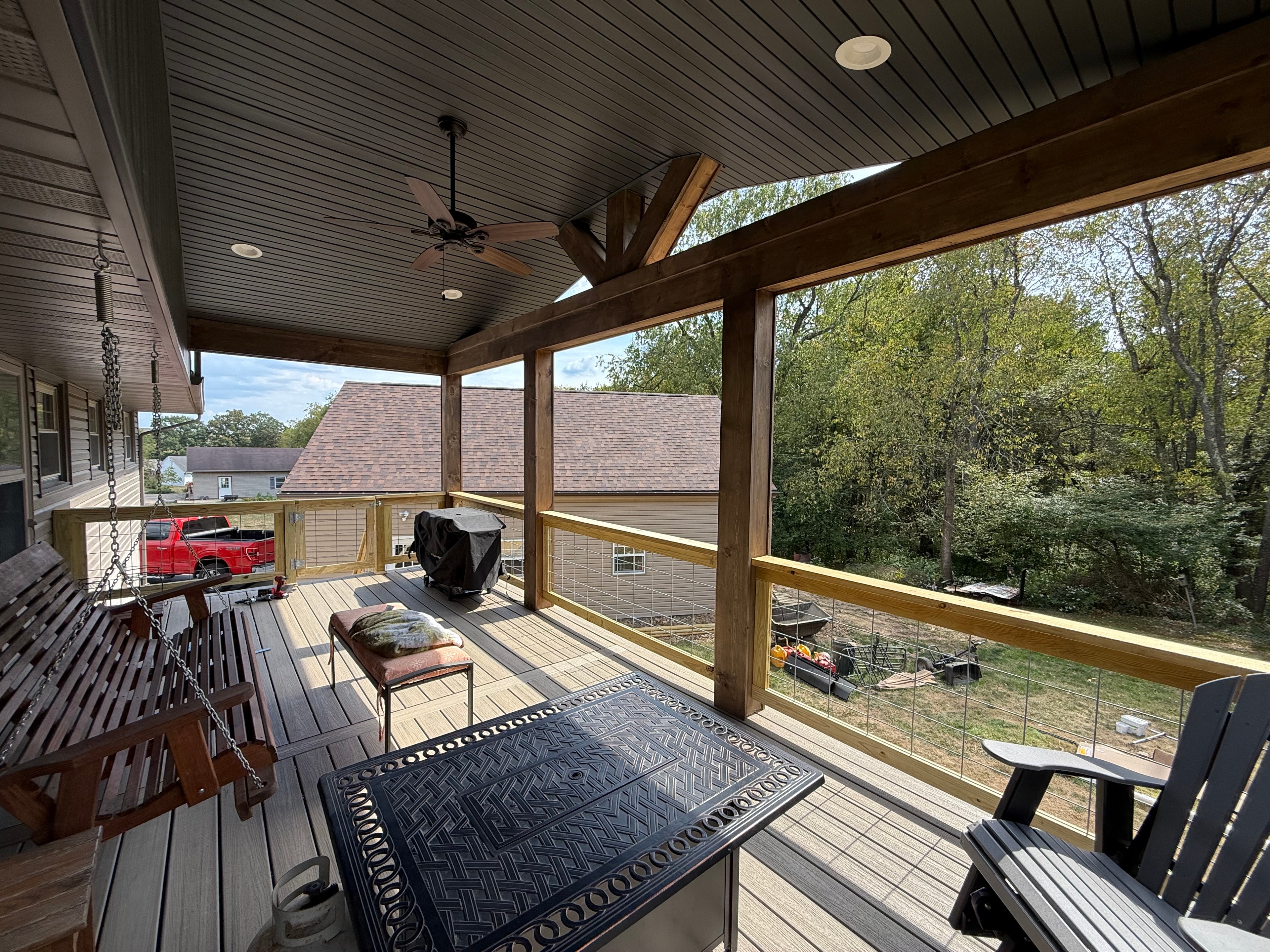 Covered deck with porch swing and outdoor furniture