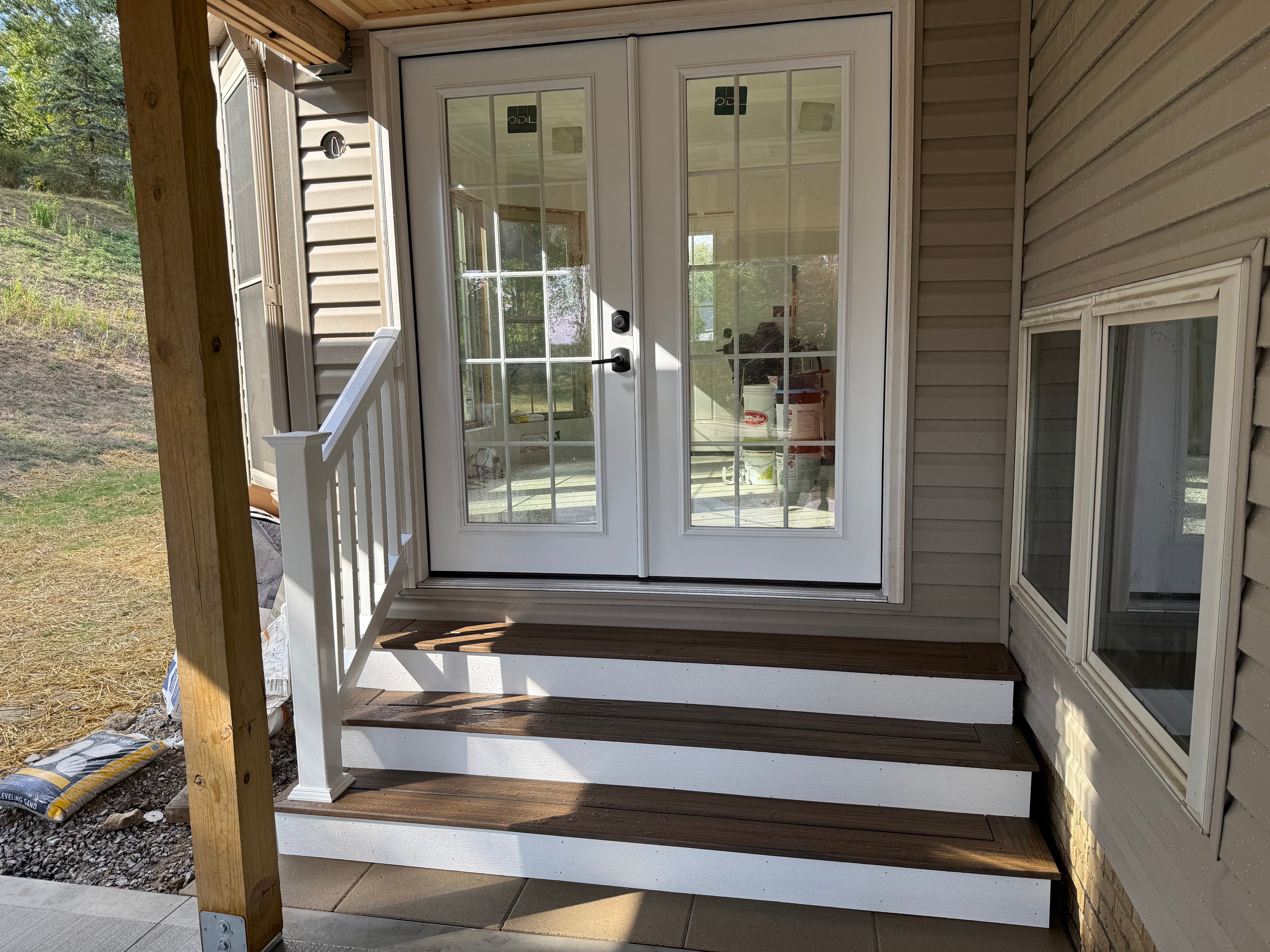Covered entry with French doors and composite steps