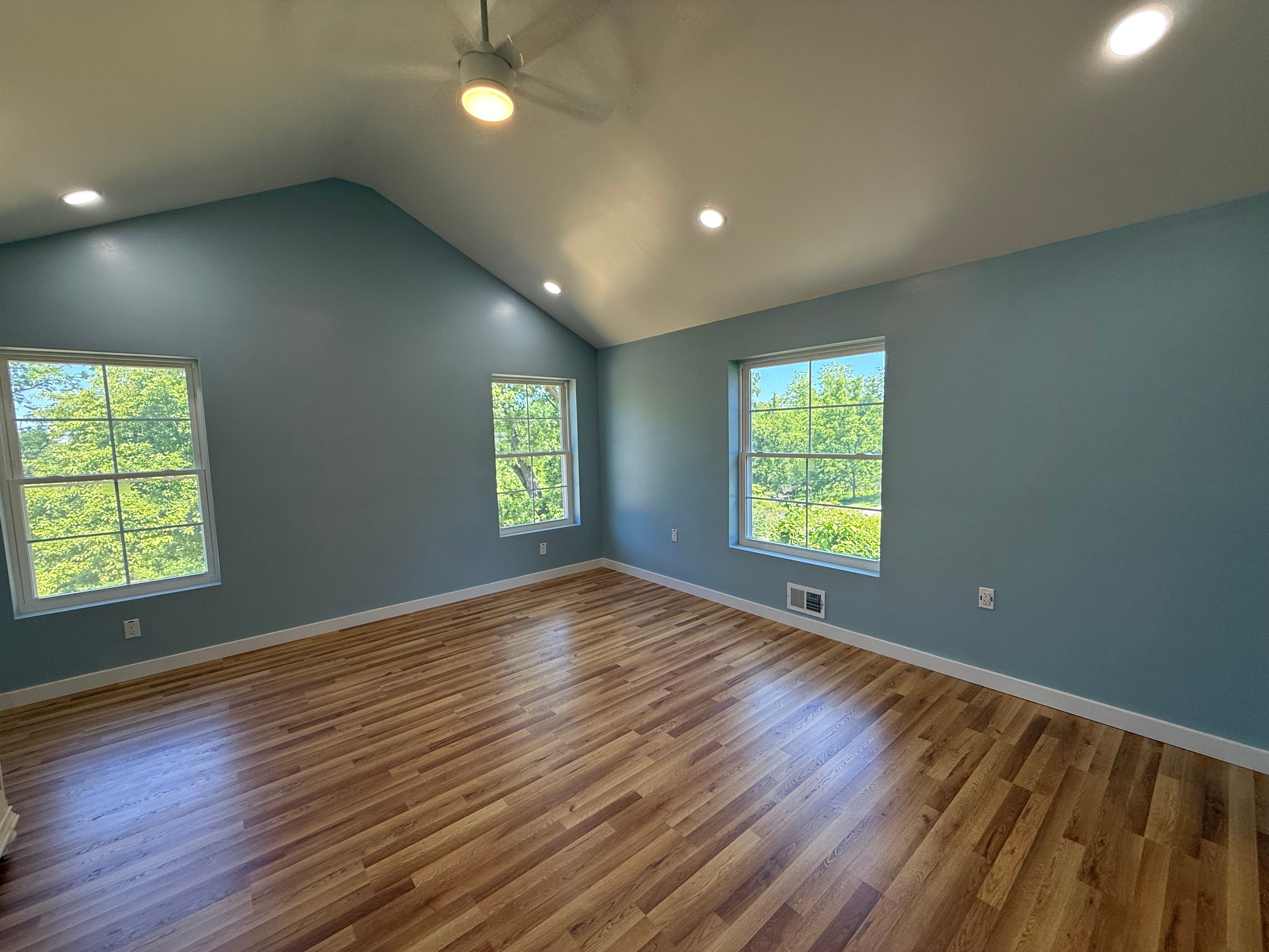 Bright bedroom interior with vaulted ceiling